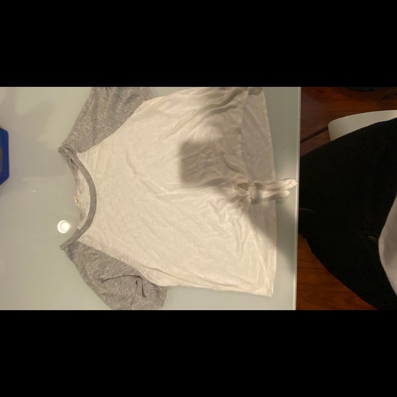 A grey and white shirt with a knot at the bottom. - Picture 1 of 3